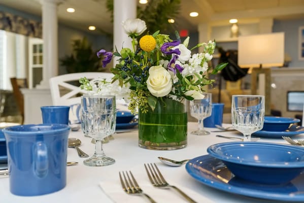 Beautifully set dining table with floral centerpiece