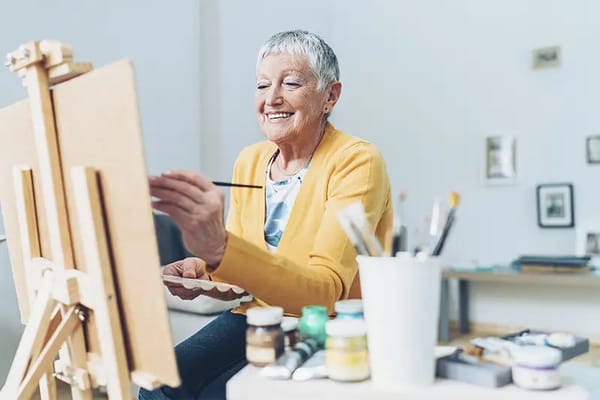 Senior woman painting in an art room