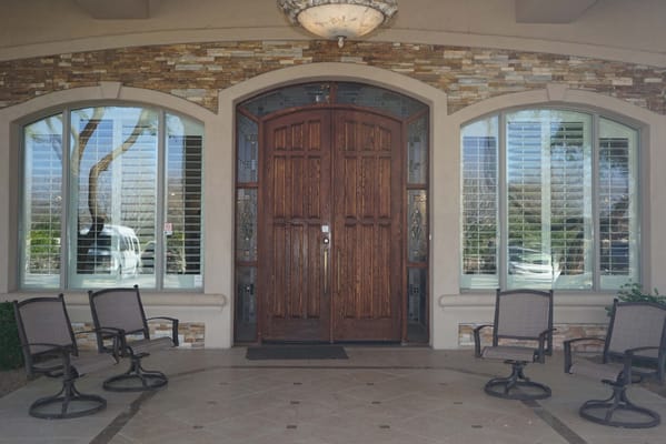 Entrance with wooden doors and seating area