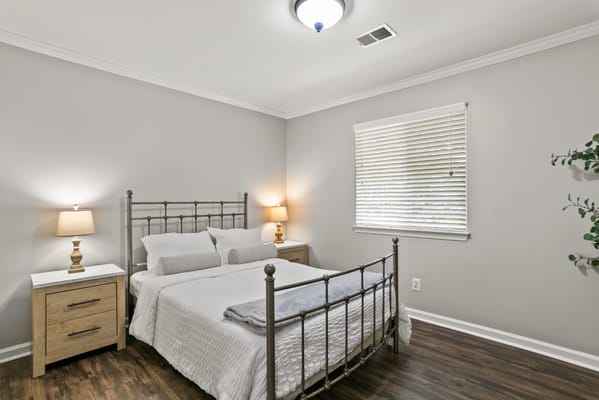 Cozy private room with a bed and bedside table