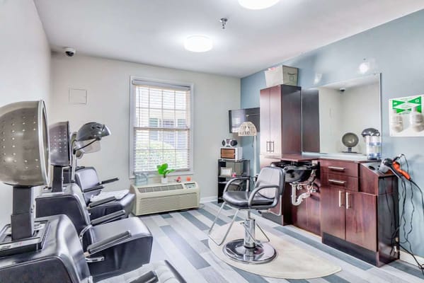 Bright hair salon area with styling chairs and mirrors