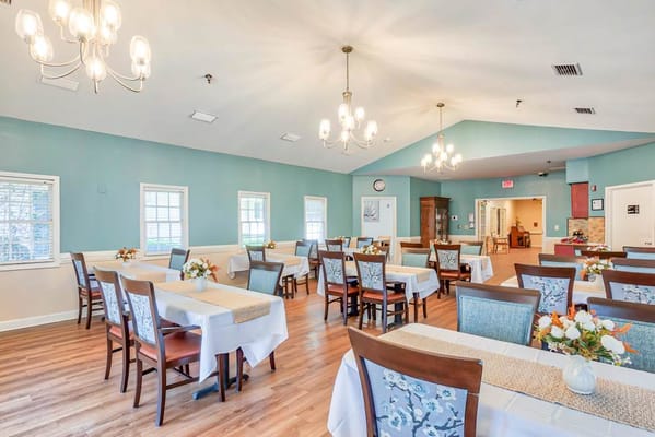 Bright dining room with tables set for residents