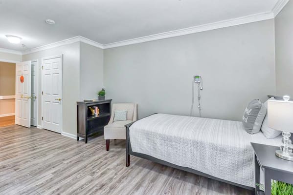 Private resident room with a bed and chair