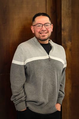 A man smiling in a casual sweater