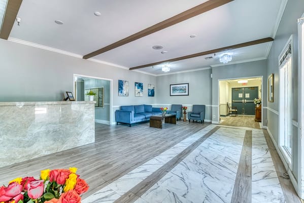 Bright lobby area with seating and flowers