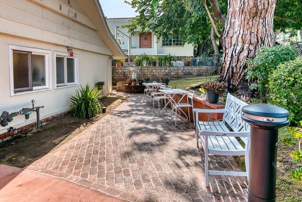 Outdoor seating area with brick pathway and plants