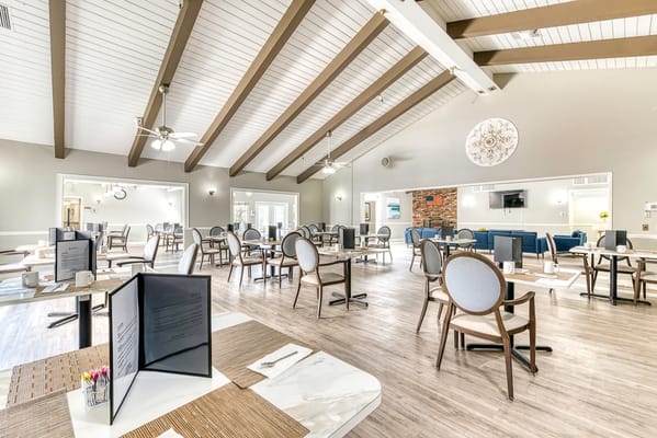 Bright and spacious dining area with tables and chairs