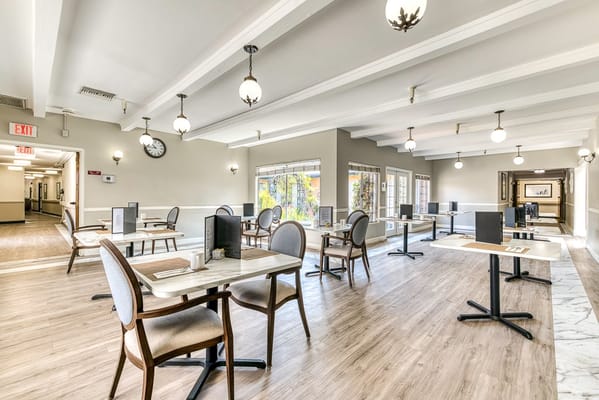 Bright dining room with tables and chairs arranged