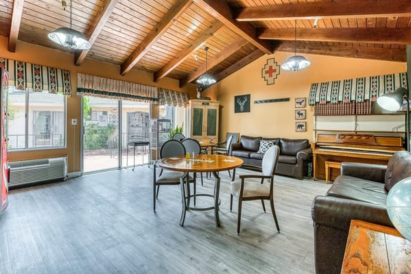 Bright common area with seating and piano