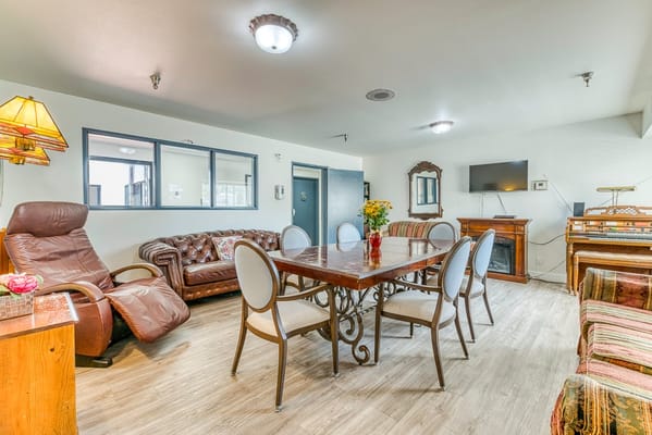 Bright common area with seating and piano