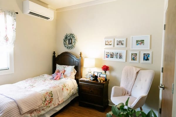Cozy resident room with floral bedding and personal decor