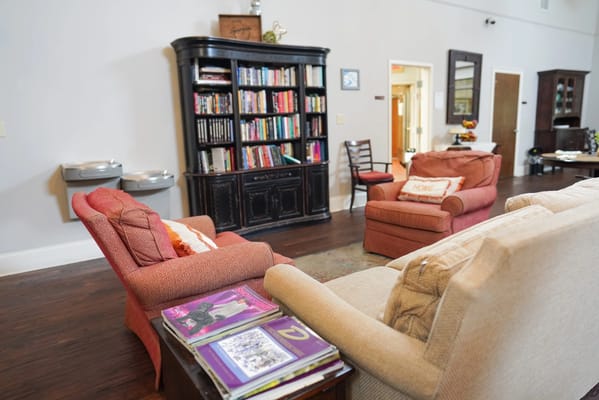 Cozy common area with seating and a bookshelf