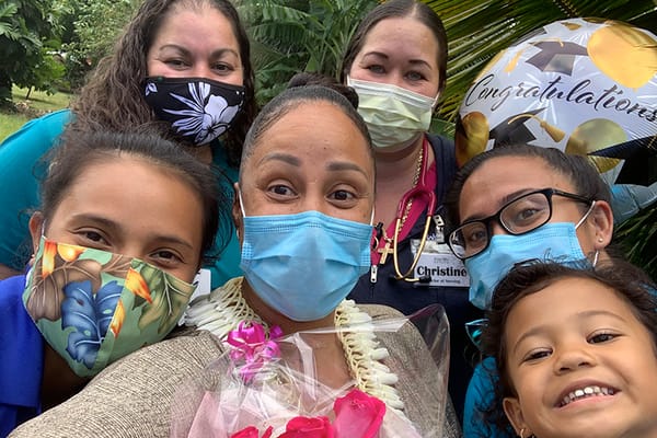 Group photo of staff and a resident celebrating