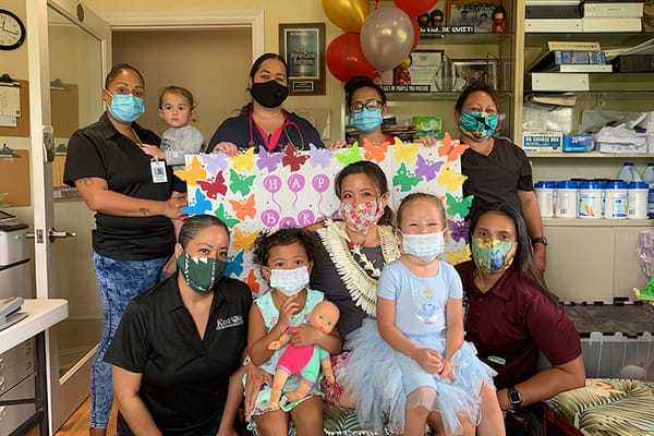 Residents and staff celebrating a birthday party indoors