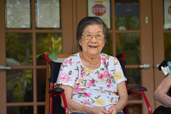 Senior resident smiling on a chair