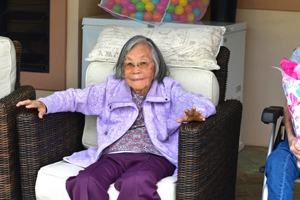 A resident sitting comfortably in an indoor area