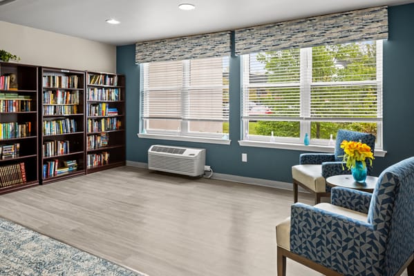 Bright common area with bookshelves and seating