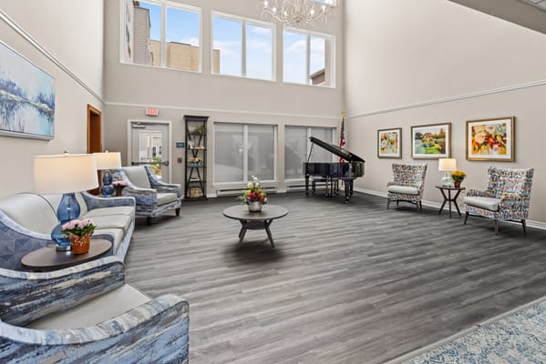 Bright common area with seating and piano