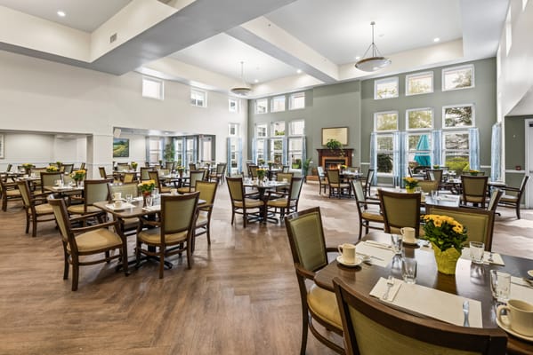 Bright dining room with tables set for meals