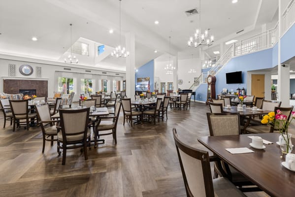 Bright dining room with tables set for meals