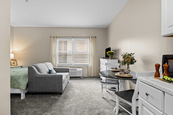 Cozy resident room with comfortable furnishings and kitchenette