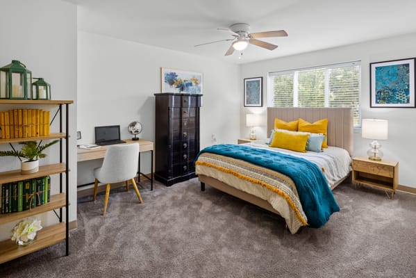 Well-decorated private resident room with a bed and desk