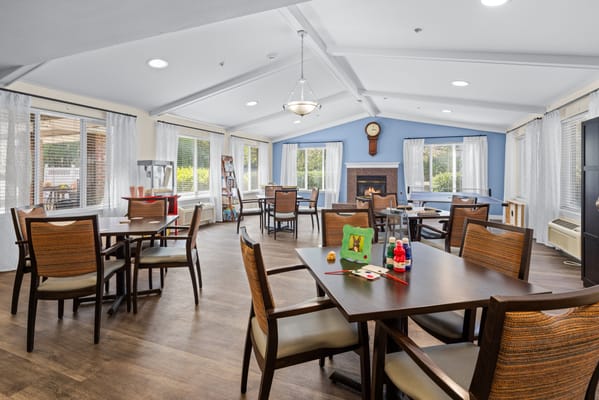 Bright and spacious common area with tables and chairs