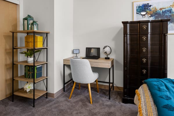 Cozy resident room with desk and bookshelf