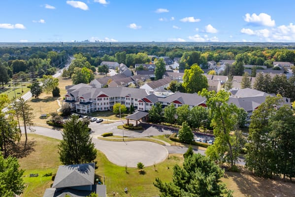 Aerial view of the senior living facility with green spaces