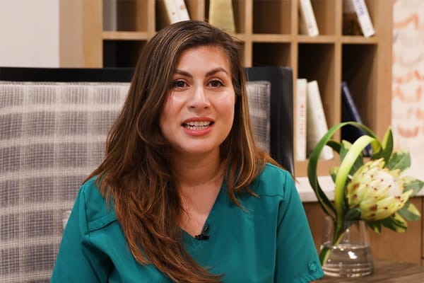 Staff member smiling in a well-lit common area