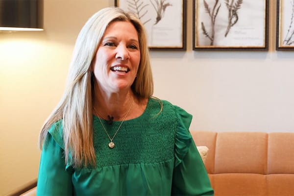 Smiling staff member in a comfortable lounge area