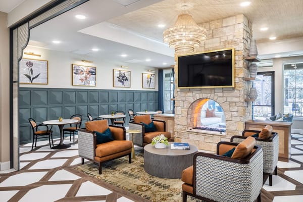 Bright common area with comfortable seating and a fireplace