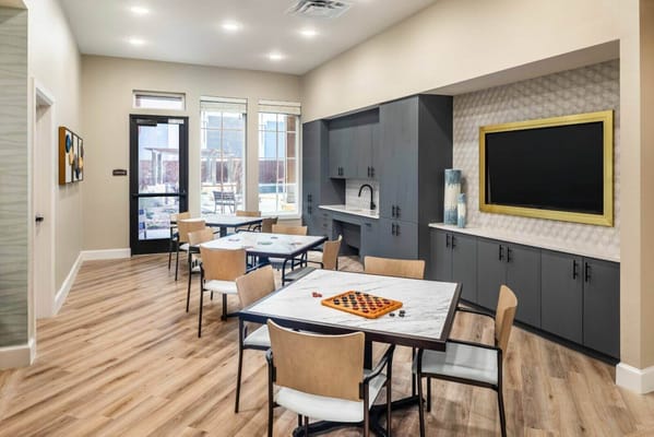 Common area with tables and seating in a bright interior