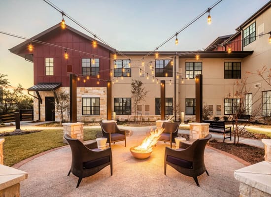 Outdoor seating area with string lights and a fire pit