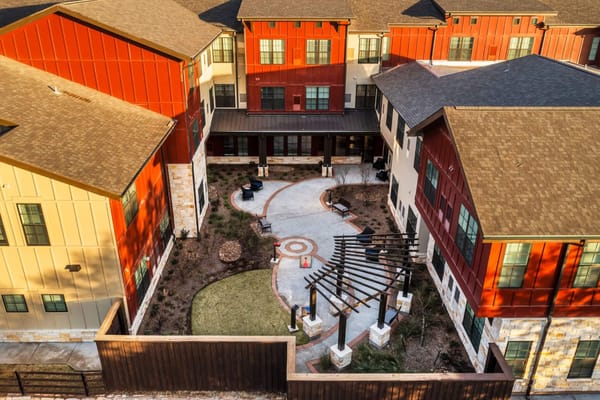 Aerial view of the Longleaf Bee Cave facility with landscaped courtyard