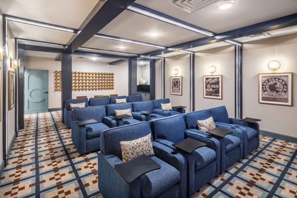 Cozy movie theater room with blue chairs and decor