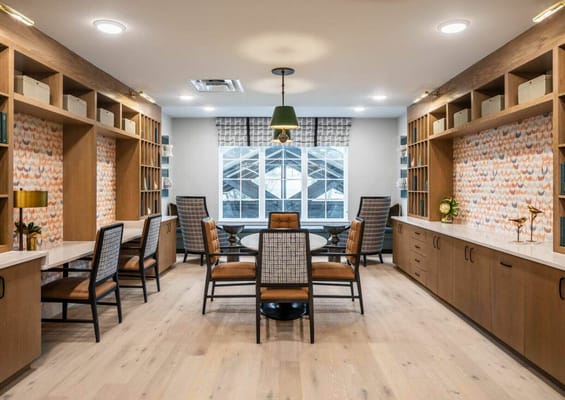 Bright common area with seating and large windows