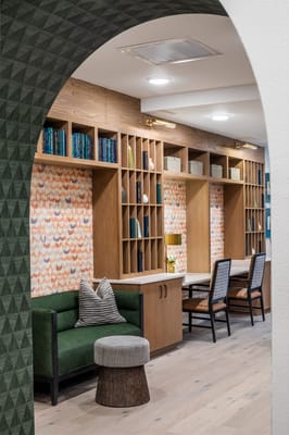 Interior of a cozy common area with bookshelves and seating