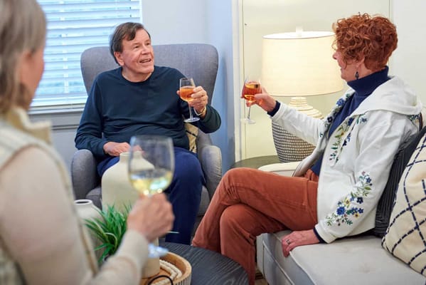 Residents enjoying drinks together in a cozy common area