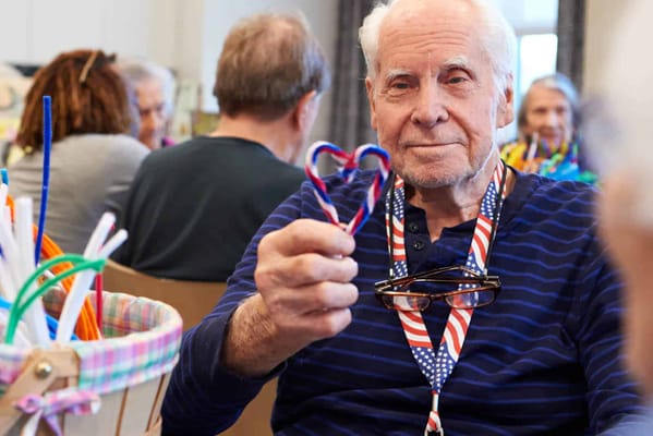 Resident crafting a heart with pipe cleaners