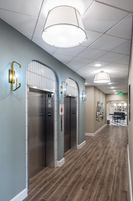 Interior hallway with elevators and decorative lighting