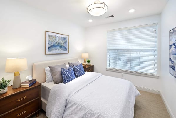 Cozy interior of a private resident room with a bed and lamp