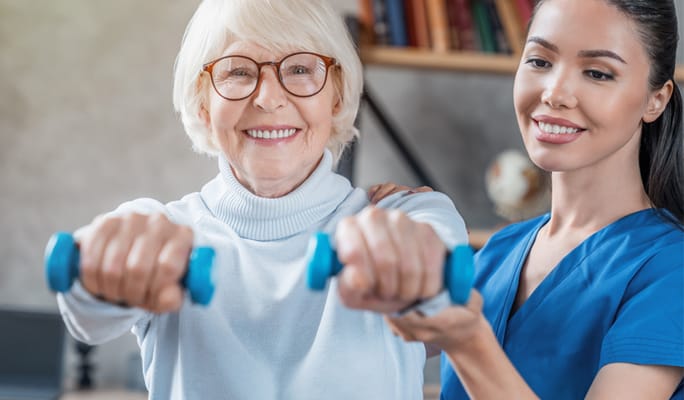 Senior resident exercising with a staff member
