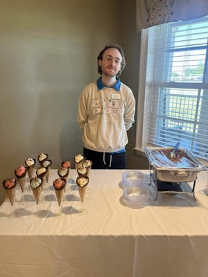 Staff member serving ice cream in a common area