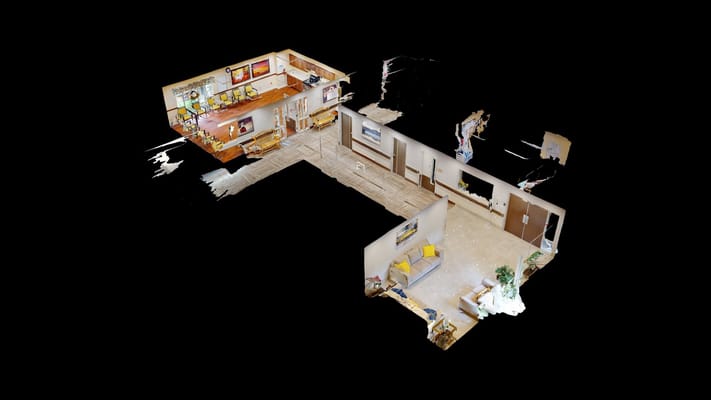 A spacious common area with seating and artwork at Complete Care at Bey Lea.