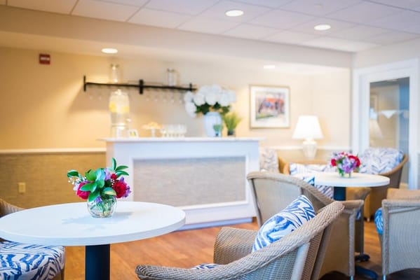 Bright common area with seating and flower arrangements