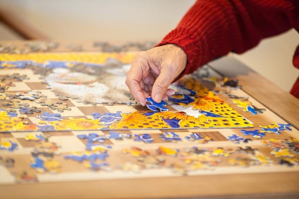A resident working on a colorful jigsaw puzzle