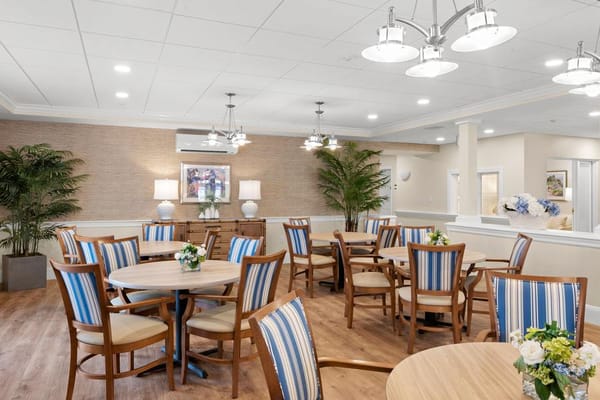 Bright dining room with wooden tables and plants