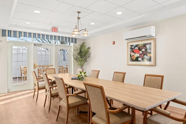 Bright common area with a large table and chairs