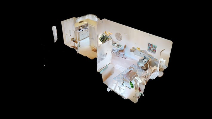 A modern living space featuring a kitchen, seating area, and decorative elements.